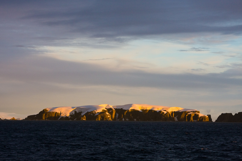 Snow Covered Headland At Sunset